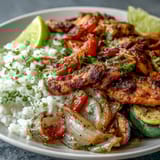 Golden roasted chicken and vibrant bell peppers sizzling on a sheet pan for a Sheet Pan Fajita Bowl.