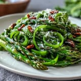 Bright, crisp asparagus ribbons tossed with lemon dressing and topped with shaved Parmesan cheese.