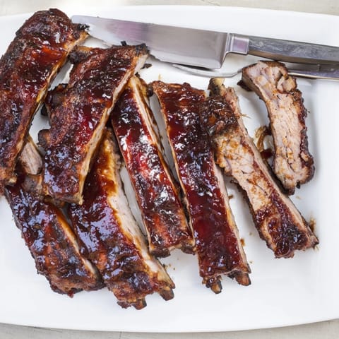 Freshly grilled BBQ Ribs seasoned with paprika and served alongside creamy coleslaw.