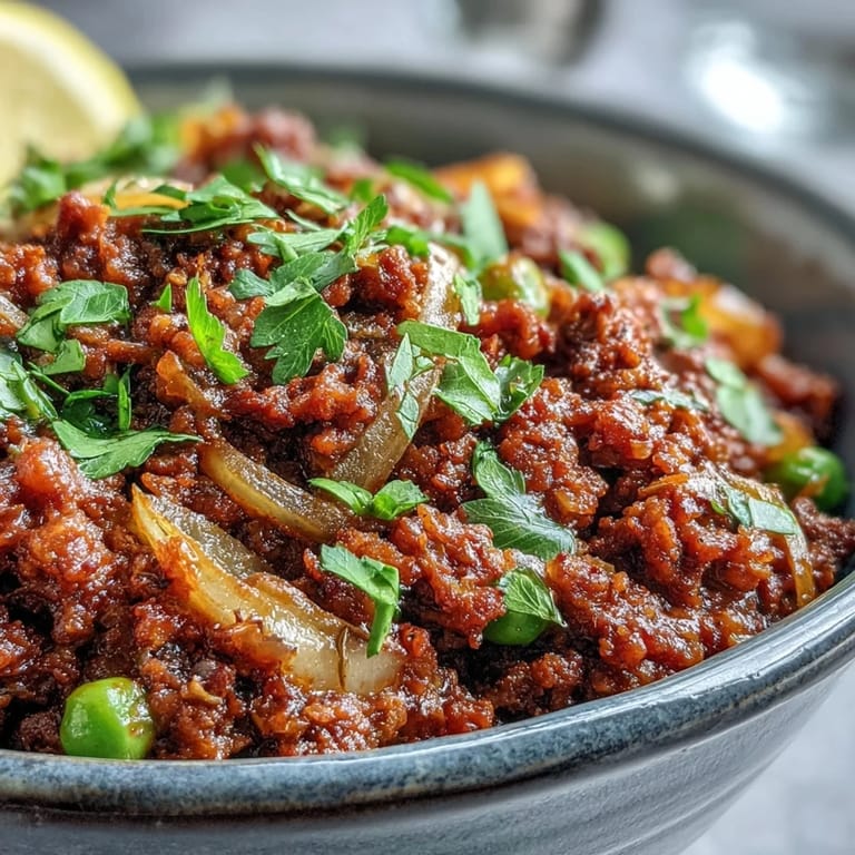Ground venison simmered in a rich, aromatic Venison Keema Curry served with fresh cilantro.