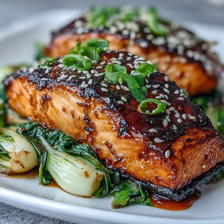 Tender, caramelized miso salmon fillet served with crisp sesame bok choy, ready to eat.