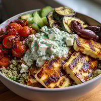 Freshly grilled zucchini and red bell peppers charred to perfection, nestled over nutty quinoa in this Healthy Grilled Mediterranean Bowl.