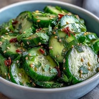 Crisp Asian cucumber salad with sesame and rice vinegar, perfect for a light, refreshing side dish.  