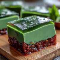 Yokan Japanese Red Bean Jelly with Matcha Layer, beautifully sliced, showcasing vibrant green and earthy red hues.